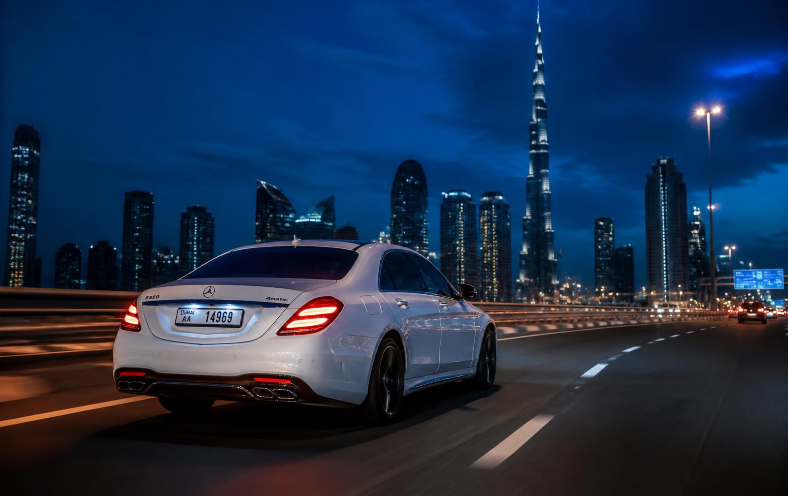 Luxury car driving on Sheikh Zayed Road with the Dubai skyline at dusk